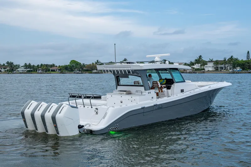 Slide: The Image of 2025 HCB 48 Campeon boat with multiple engines on a calm waterway. - 15