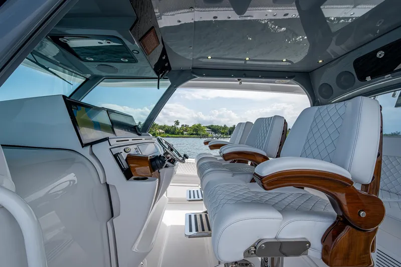 Slide: The Image of Luxurious interior of 2025 HCB 48 Campeon boat with plush seating and modern controls. - 20