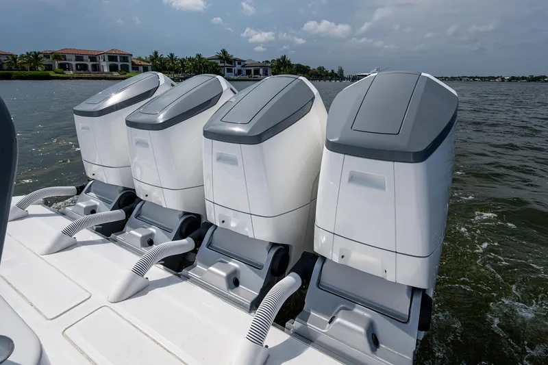 Slide: The Image of Four powerful outboard engines on a 2025 HCB 48 Campeon boat, cruising on a sunny day. - 26