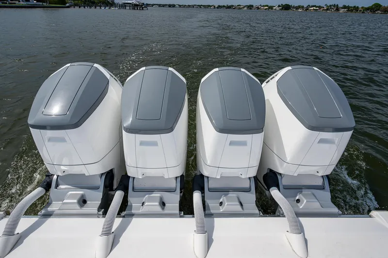 Slide: The Image of Four powerful outboard engines on a 2025 HCB 48 Campeon boat, cruising on open water. - 27