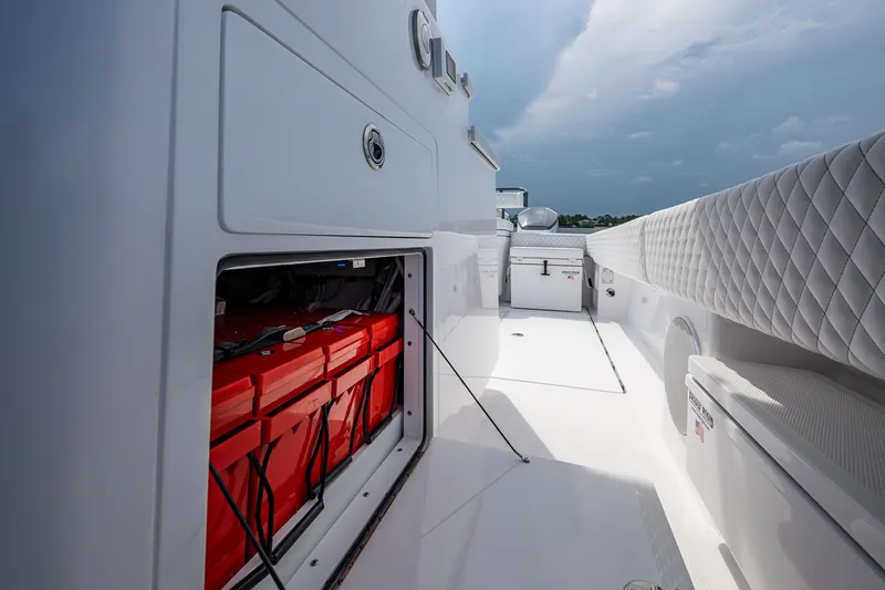 Slide: The Image of 2025 HCB 48 Campeon boat interior with open storage compartment and quilted seating. - 33