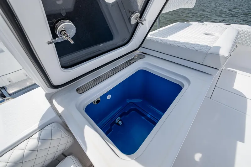 Slide: The Image of HCB 48 Campeon 2025 boat with open storage compartment, featuring quilted seating. - 38