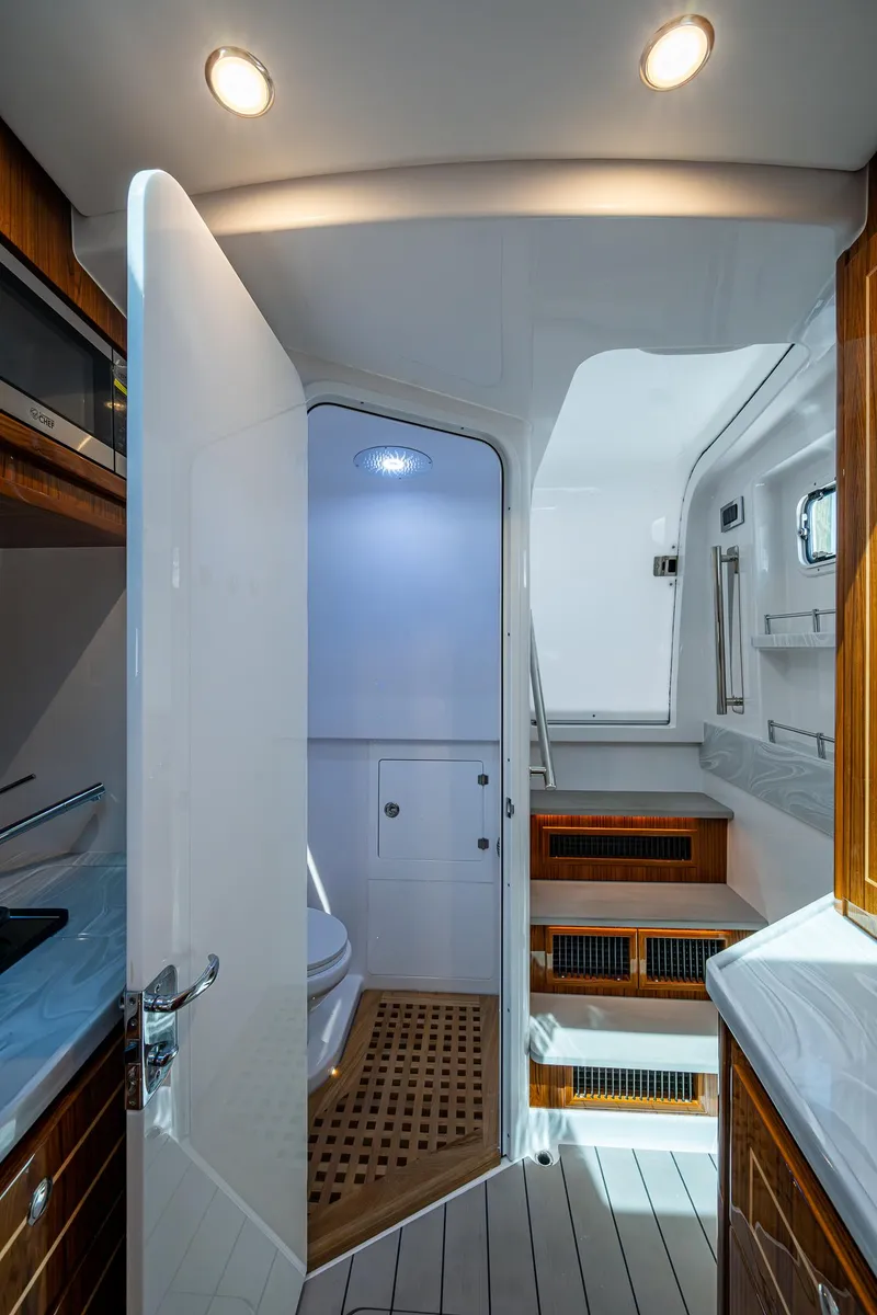 Slide: The Image of Interior of 2025 HCB 48 Campeon yacht, featuring modern bathroom and wooden accents. - 48