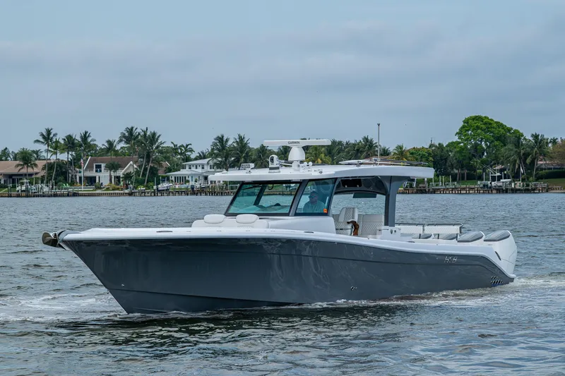 Slide: The Image of 2025 HCB 48 Campeon boat cruising on a calm waterway. - 5