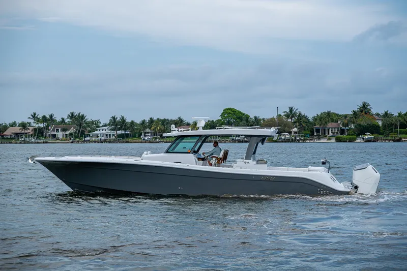 Slide: The Image of 2025 HCB 48 Campeon boat cruising on a calm waterway. - 9