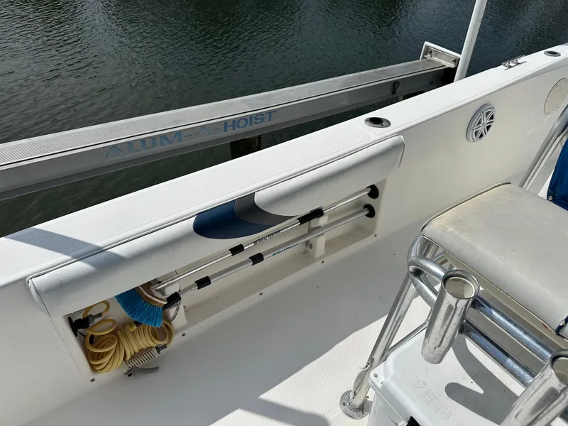 Slide: The Image of 2003 Cobia 254 Center Console boat interior with storage and seating, featuring twin Yamahas and Rhodan. - 12