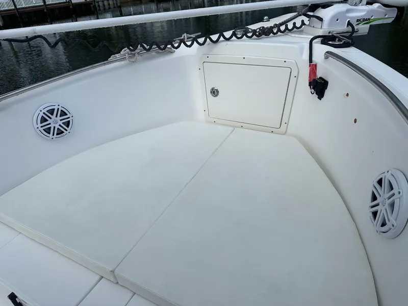 Slide: The Image of 2003 Cobia 254 Center Console boat interior with storage and speakers. - 7