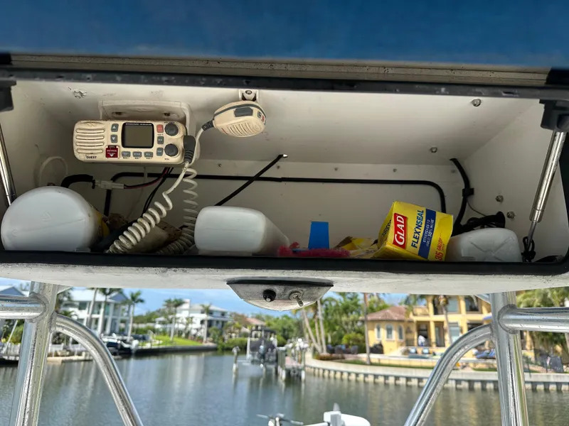 Slide: The Image of Storage compartment on a 2003 Cobia 254 Center Console boat, featuring marine equipment and supplies. - 9