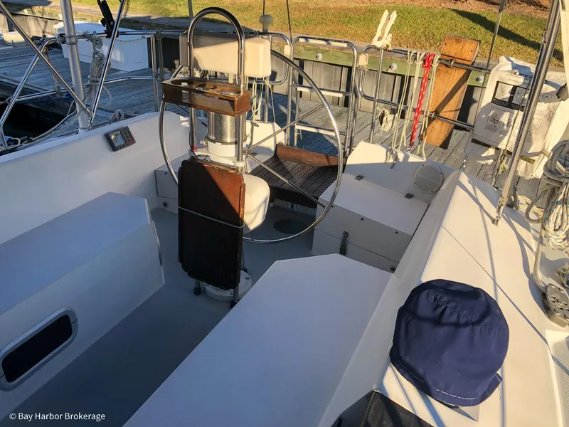 Slide: The Image of Cockpit of 1992 Catalina 42 sailboat with steering wheel and seating area. - 11