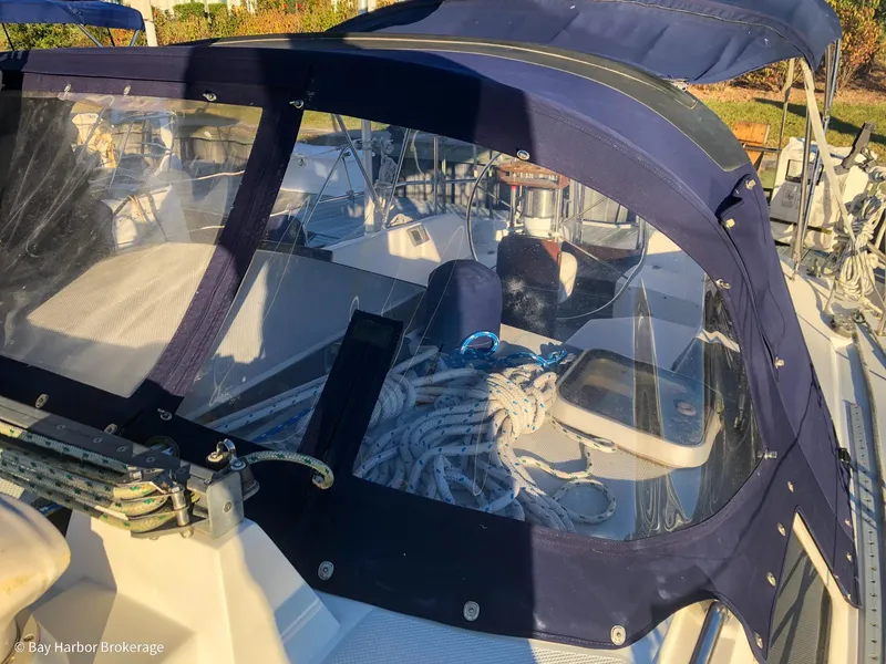 Slide: The Image of 1992 Catalina 42 sailboat cockpit with ropes and blue canvas cover. - 14