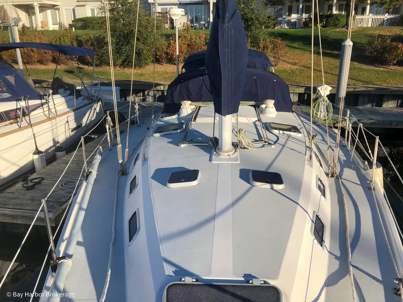 Slide: The Image of 1992 Catalina 42 sailboat docked, showcasing deck and rigging in a marina setting. - 17