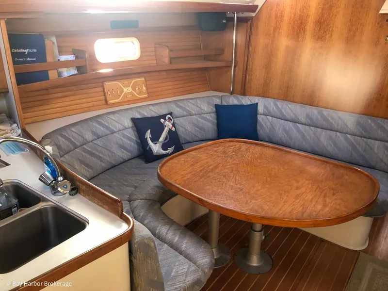 Slide: The Image of Cozy interior of 1992 Catalina 42 sailboat with wooden table and cushioned seating. - 20