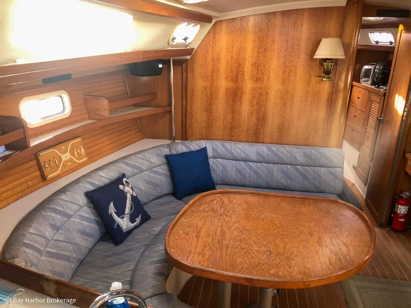 Slide: The Image of Cozy interior of 1992 Catalina 42 sailboat with wooden table and cushioned seating. - 23