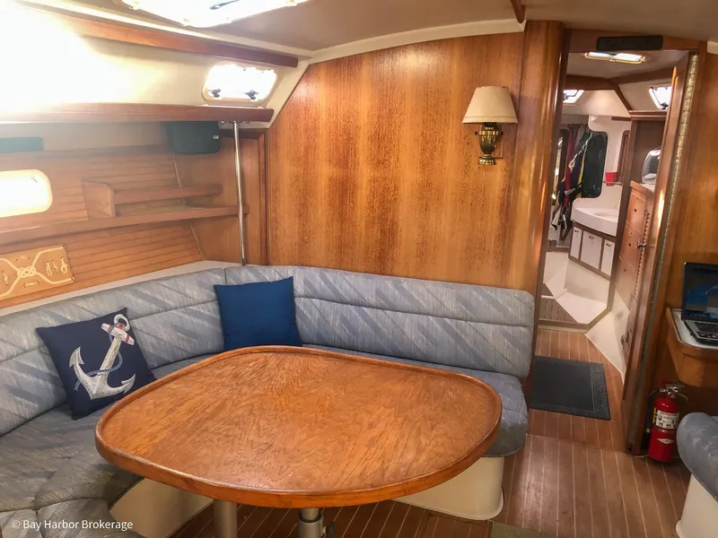 Slide: The Image of Cozy interior of 1992 Catalina 42 sailboat with wooden table and cushioned seating. - 26