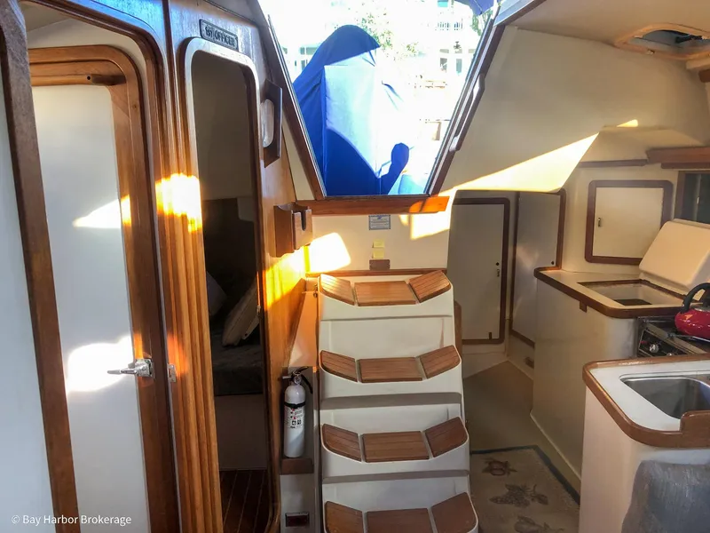Slide: The Image of Interior of a 1992 Catalina 42 sailboat with wooden accents and compact kitchen area. - 28