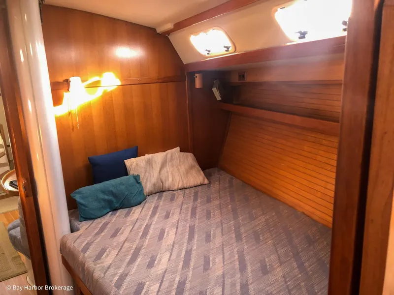 Slide: The Image of Cozy cabin interior of 1992 Catalina 42 sailboat with wooden paneling and comfortable bedding. - 29