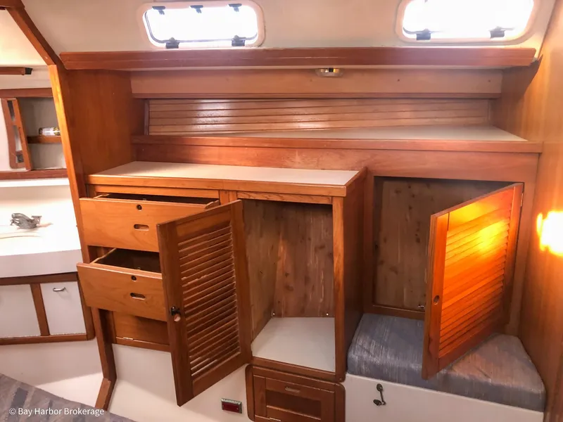 Slide: The Image of Interior of 1992 Catalina 42 sailboat with wooden cabinets and storage space. - 30