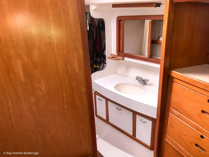 Slide: The Image of Interior of 1992 Catalina 42 sailboat showing bathroom with wooden cabinetry and sink. - 33