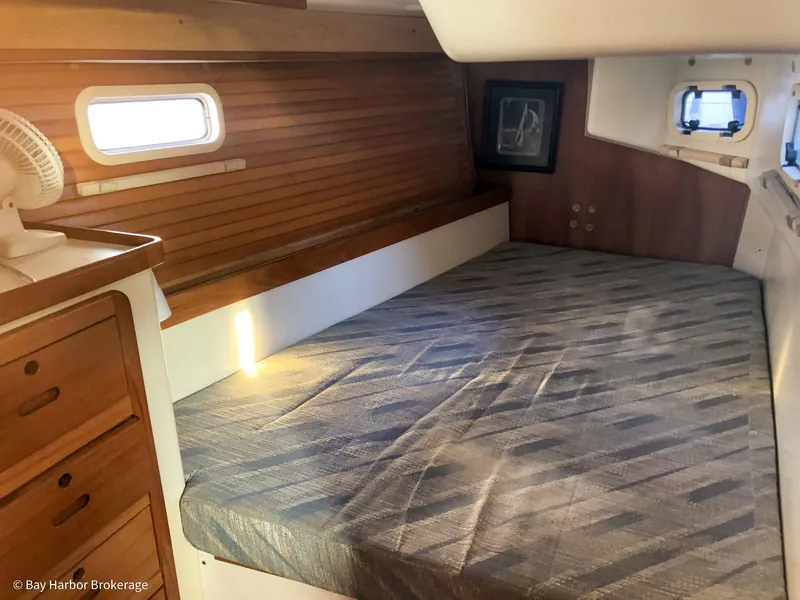 Slide: The Image of Cozy cabin interior of a 1992 Catalina 42 sailboat with wooden accents and a comfortable bed. - 34