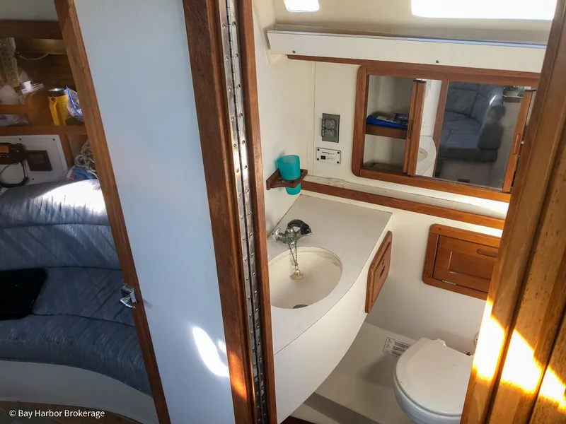 Slide: The Image of Interior of 1992 Catalina 42 sailboat showing bathroom with sink and toilet. - 38