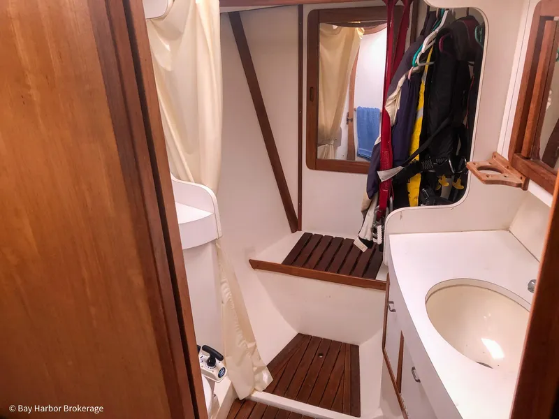 Slide: The Image of Bathroom interior of 1992 Catalina 42 sailboat with wooden accents and storage space. - 39