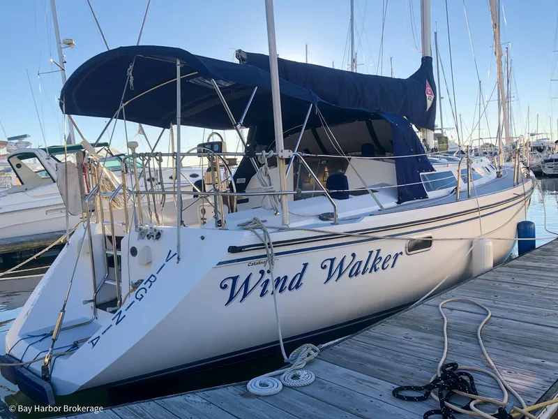 Slide: The Image of Sailboat "Wind Walker" docked, Catalina 42 model, 1992, with blue canopy and white hull. - 4