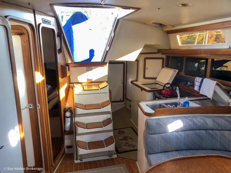 Slide: The Image of Interior of a 1992 Catalina 42 sailboat, featuring a cozy kitchen and seating area. - 41