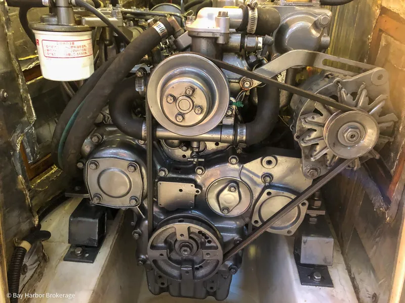 Slide: The Image of Engine of a 1992 Catalina 42 sailboat, showcasing mechanical components and belts. - 42