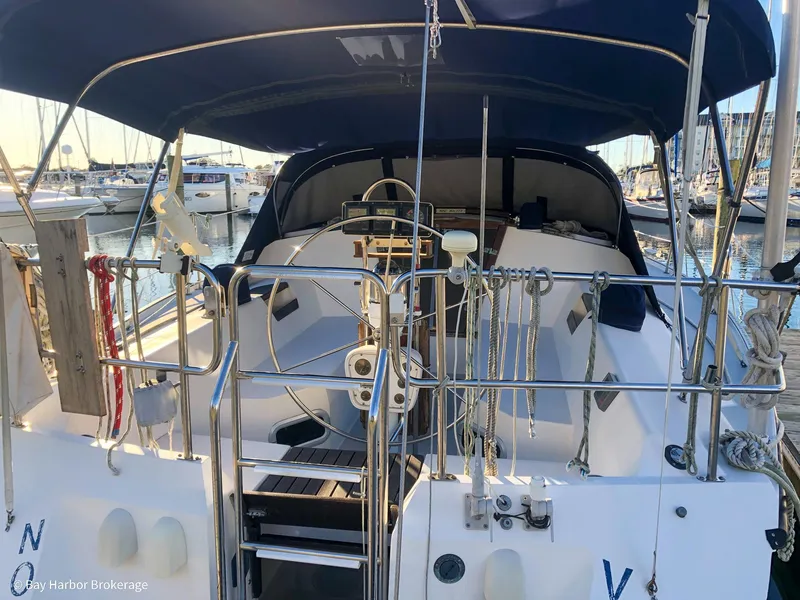 Slide: The Image of 1992 Catalina 42 sailboat with covered cockpit, docked at marina. - 7