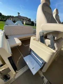 Slide: The Image of 2020 Chris-Craft Catalina 30 interior with beige seating and storage compartment. - 16