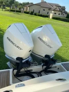 Slide: The Image of 2020 Chris-Craft Catalina 30 with twin Mercury outboard engines in a grassy residential area. - 18