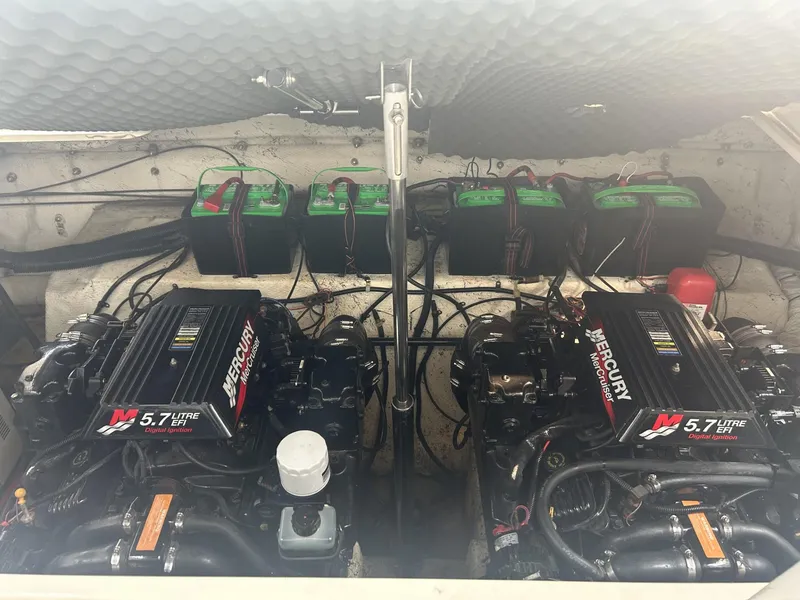 Slide: The Image of 2002 Rinker 342 Fiesta Vee engine compartment with dual Mercury 5.7L engines and batteries. - 11