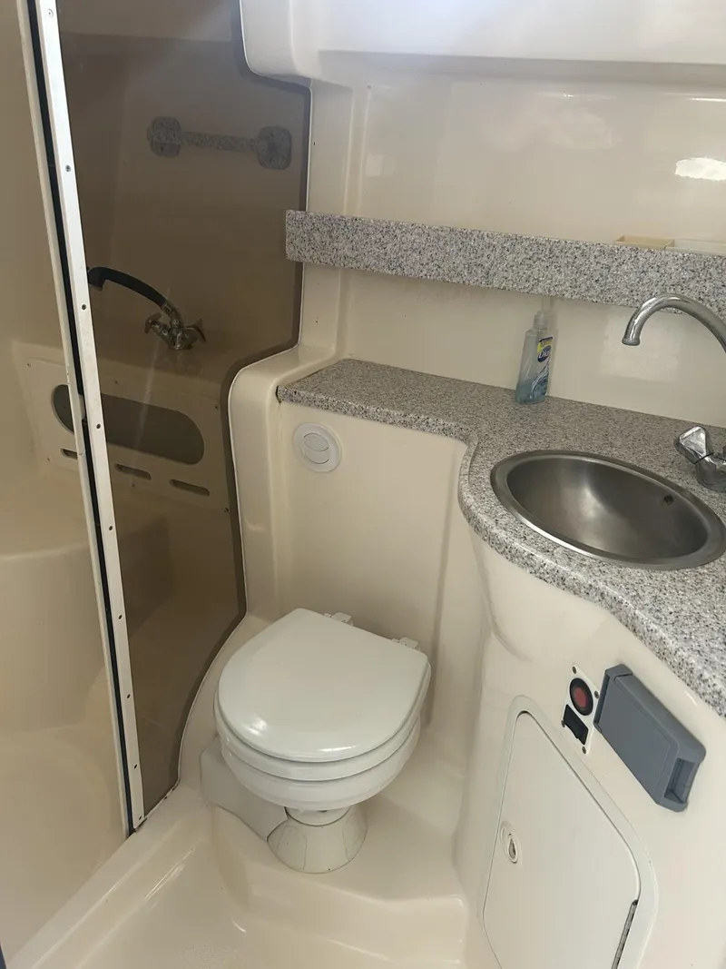 Slide: The Image of 2002 Rinker 342 Fiesta Vee boat bathroom with toilet, sink, and shower. - 13