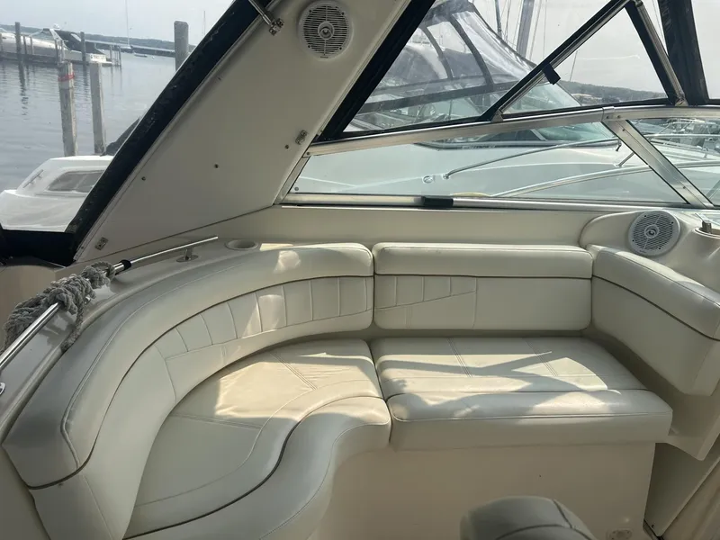 Slide: The Image of 2002 Rinker 342 Fiesta Vee boat interior with white leather seating and marina view. - 4