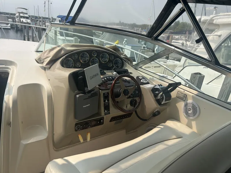 Slide: The Image of 2002 Rinker 342 Fiesta Vee boat cockpit with steering wheel and navigation instruments. - 6
