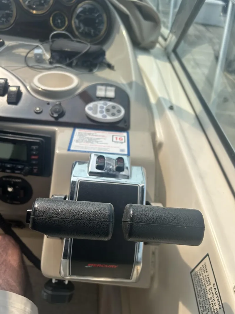 Slide: The Image of 2002 Rinker 342 Fiesta Vee boat controls and dashboard with gauges and throttle levers. - 8