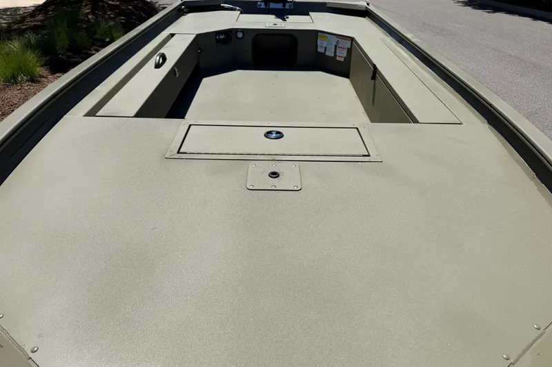 Slide: The Image of 2025 Tracker Grizzly 1654 T Sportsman boat interior, showcasing spacious deck and storage compartments. - 9