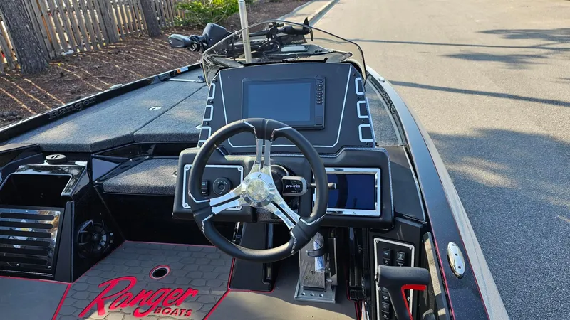 Slide: The Image of 2025 Ranger Z519R Cup-Equipped boat dashboard with steering wheel and electronic displays. - 8