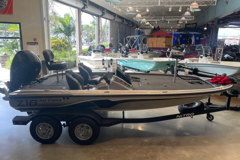 Slide: The Image of 2024 Nitro Z18 boat displayed in a showroom with other boats. - 1