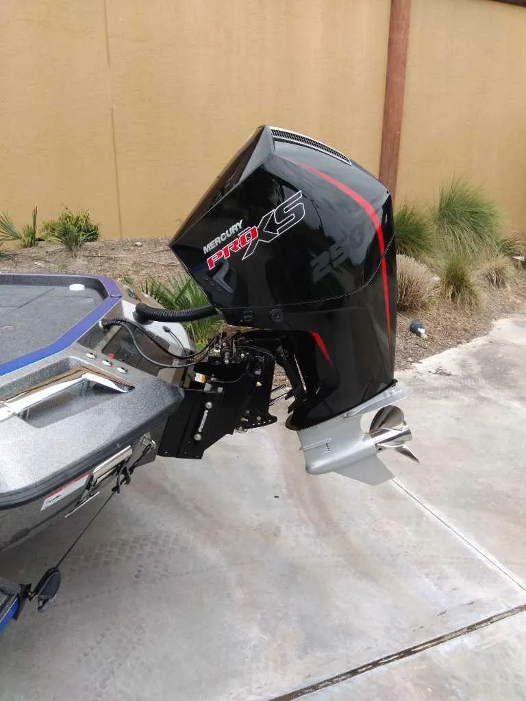 Slide: The Image of 2025 Ranger Z521R boat with Mercury Pro XS outboard motor, parked on concrete. - 5