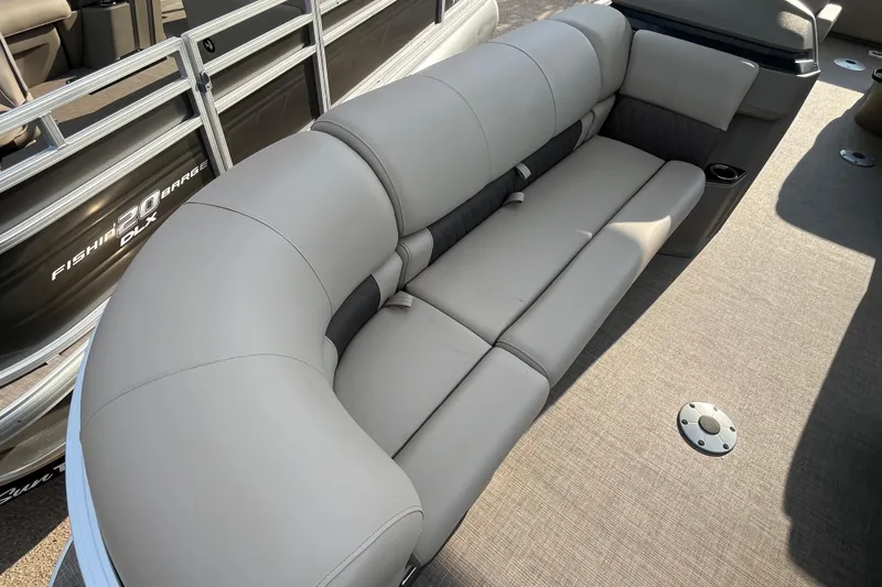 Slide: The Image of 2025 Sun Tracker SportFish 22 DLX pontoon boat with comfortable gray seating. - 3