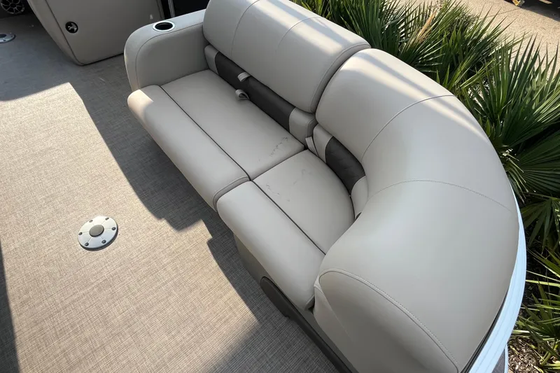 Slide: The Image of 2025 Sun Tracker SportFish 22 DLX boat seating with beige upholstery and cup holder. - 4