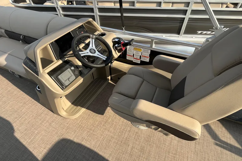 Slide: The Image of 2025 Sun Tracker SportFish 22 DLX boat interior with steering wheel and captain's chair. - 6