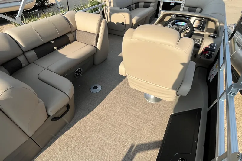 Slide: The Image of 2025 Sun Tracker SportFish 22 DLX interior with beige seating and modern helm. - 7
