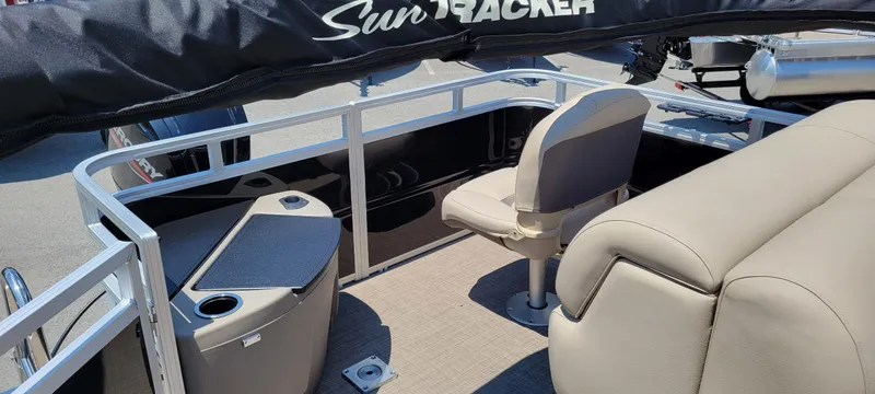 Slide: The Image of 2025 Sun Tracker SportFish 20 DLX pontoon boat interior with seating and storage. - 2