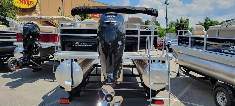 Slide: The Image of 2025 Sun Tracker SportFish 20 DLX pontoon boat with Mercury outboard motor in a parking lot. - 4