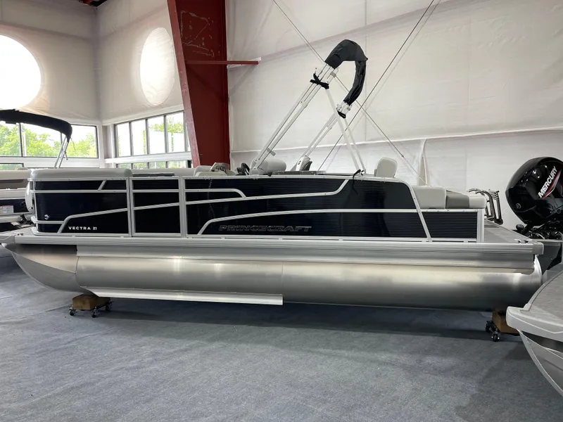 The Image of 2025 Princecraft Vectra 21 RL pontoon boat in showroom, featuring sleek design and modern amenities. - 1