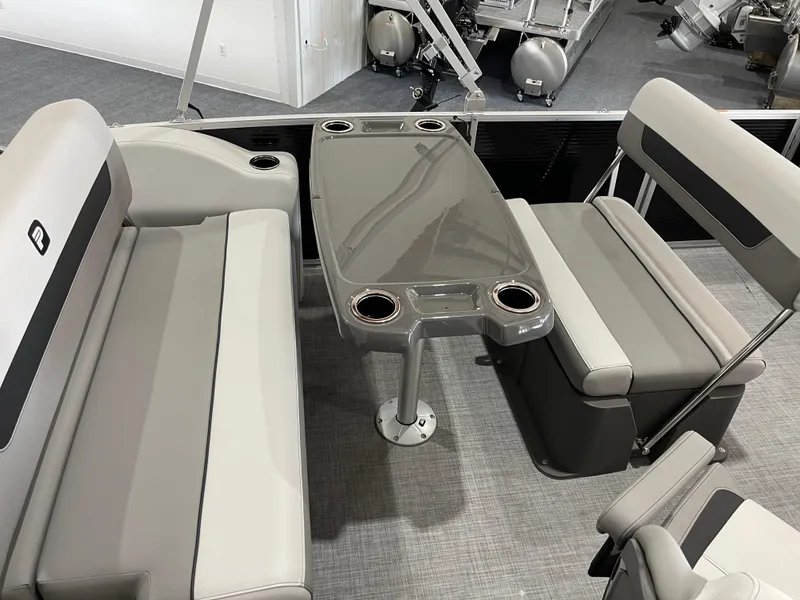 Slide: The Image of 2025 Princecraft Vectra 21 RL interior with gray seating and table, featuring cup holders. - 13
