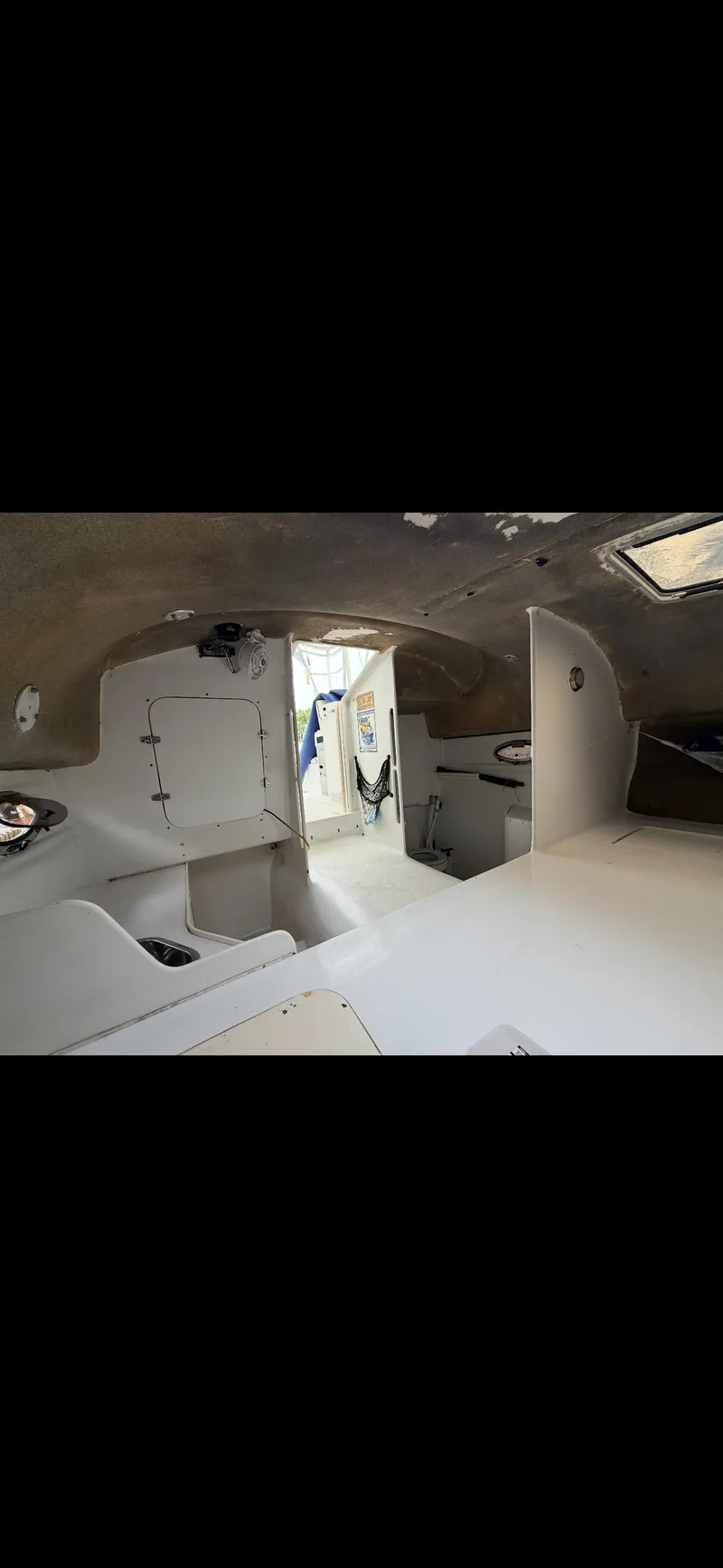 Slide: The Image of Interior of a 2000 Powercat Catamaran, showcasing spacious cabin design and storage areas. - 10