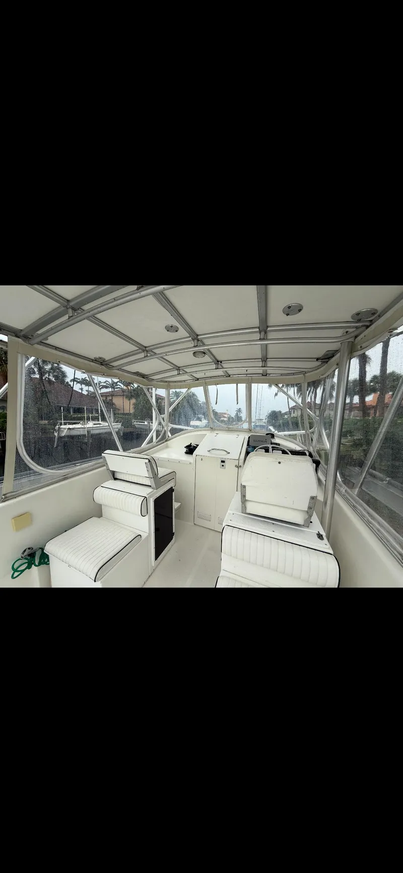 Slide: The Image of 2000 Powercat Catamaran interior with seating and helm, featuring a covered deck. - 4